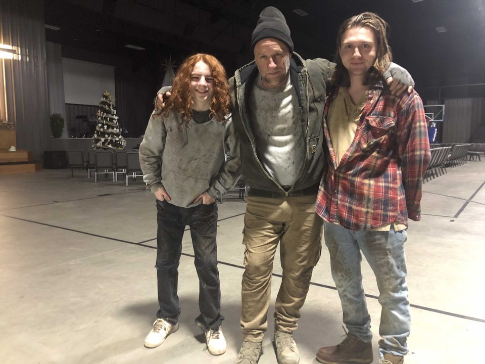 The three leads smiling together at an early rehearsal, months before principal photography.