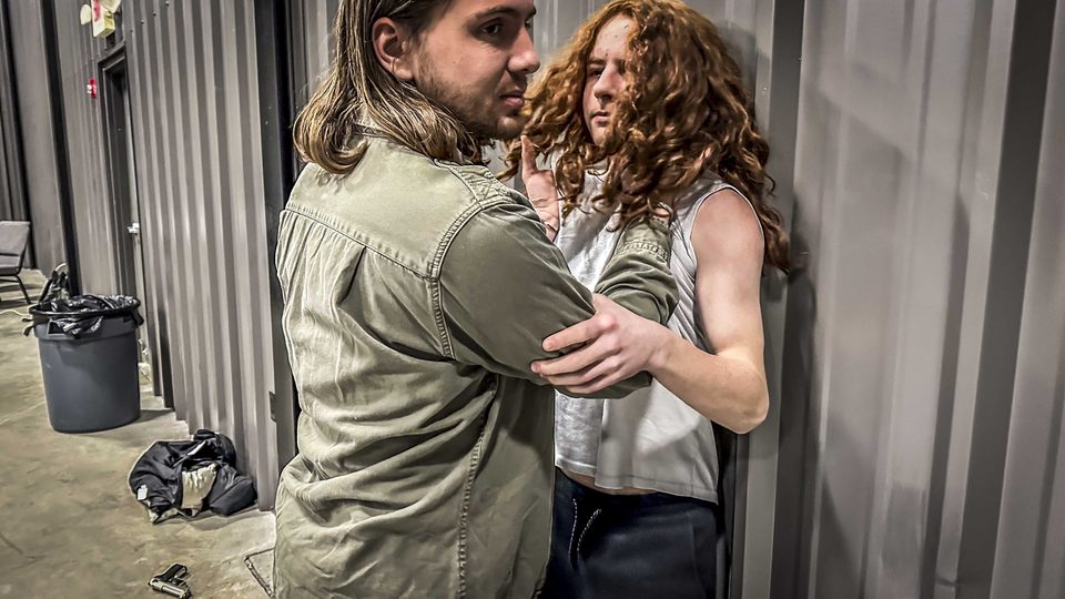 Two actors rehearse a physical confrontation against a wall, months before principal photography.