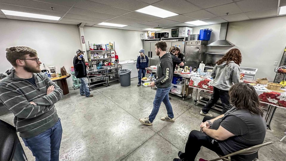 Cast and crew gathered around tables on a lunch break.