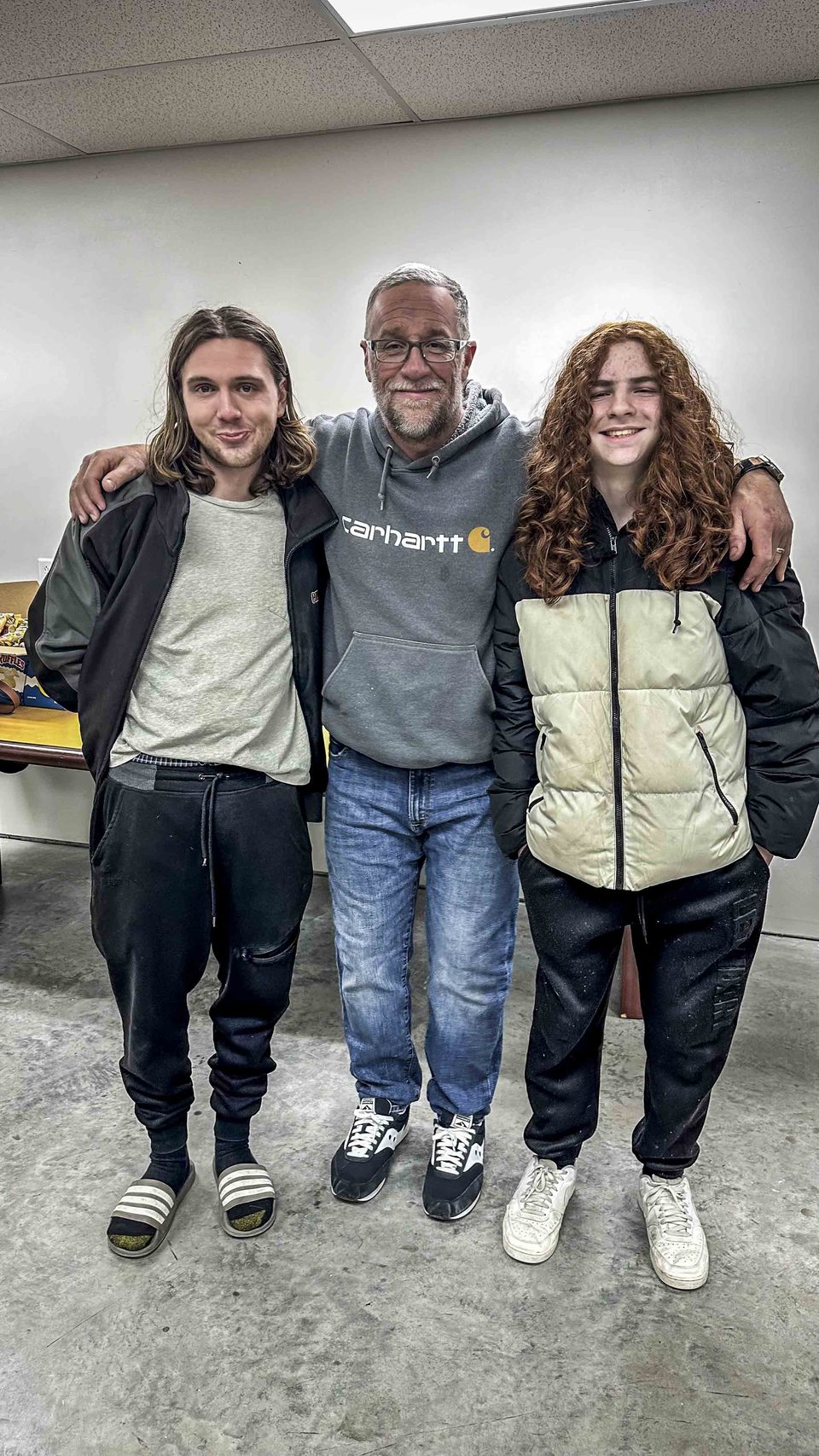 Three crew members posing together after a shoot day.